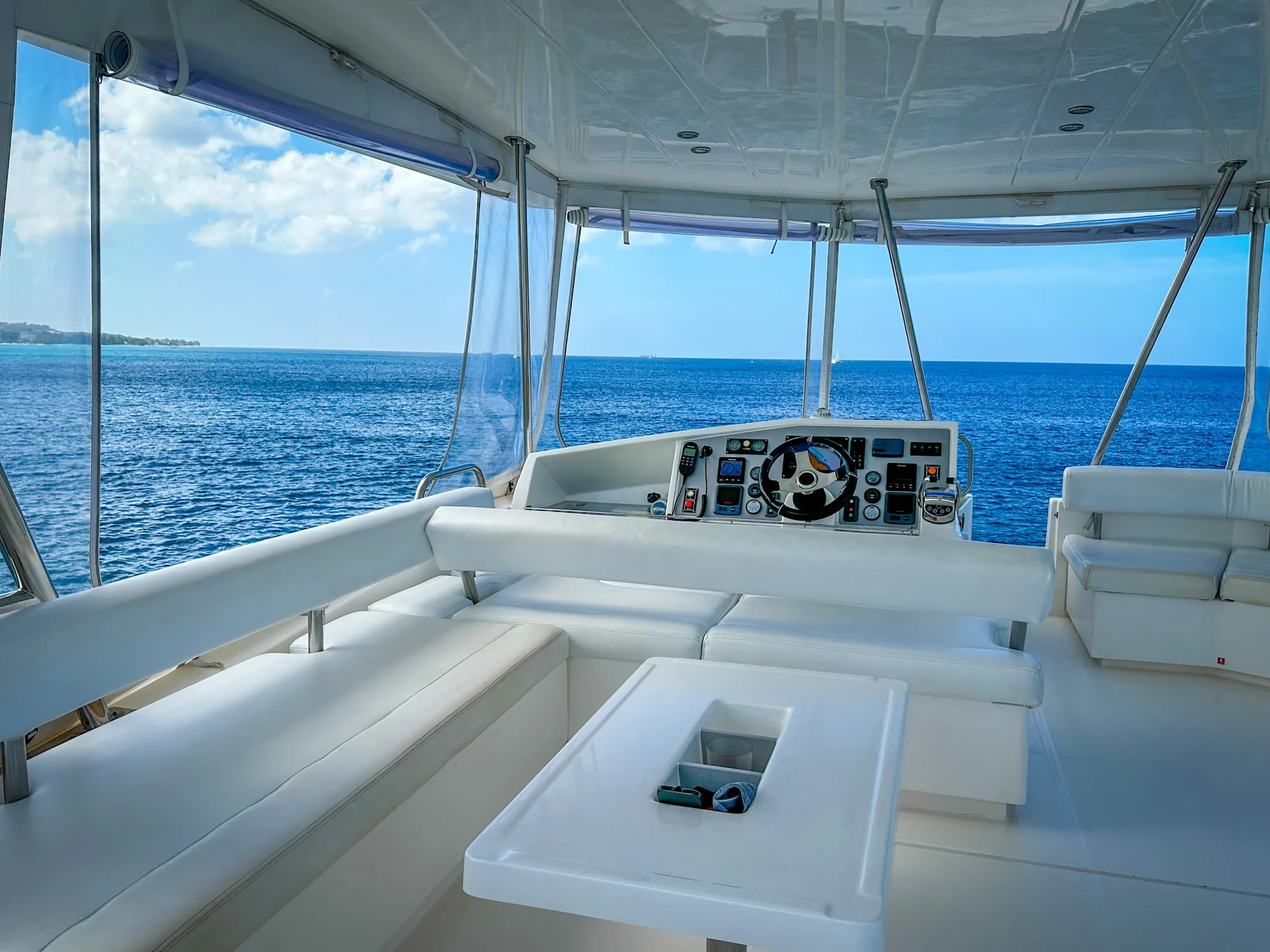 Flybridge helm station with panoramic ocean views
