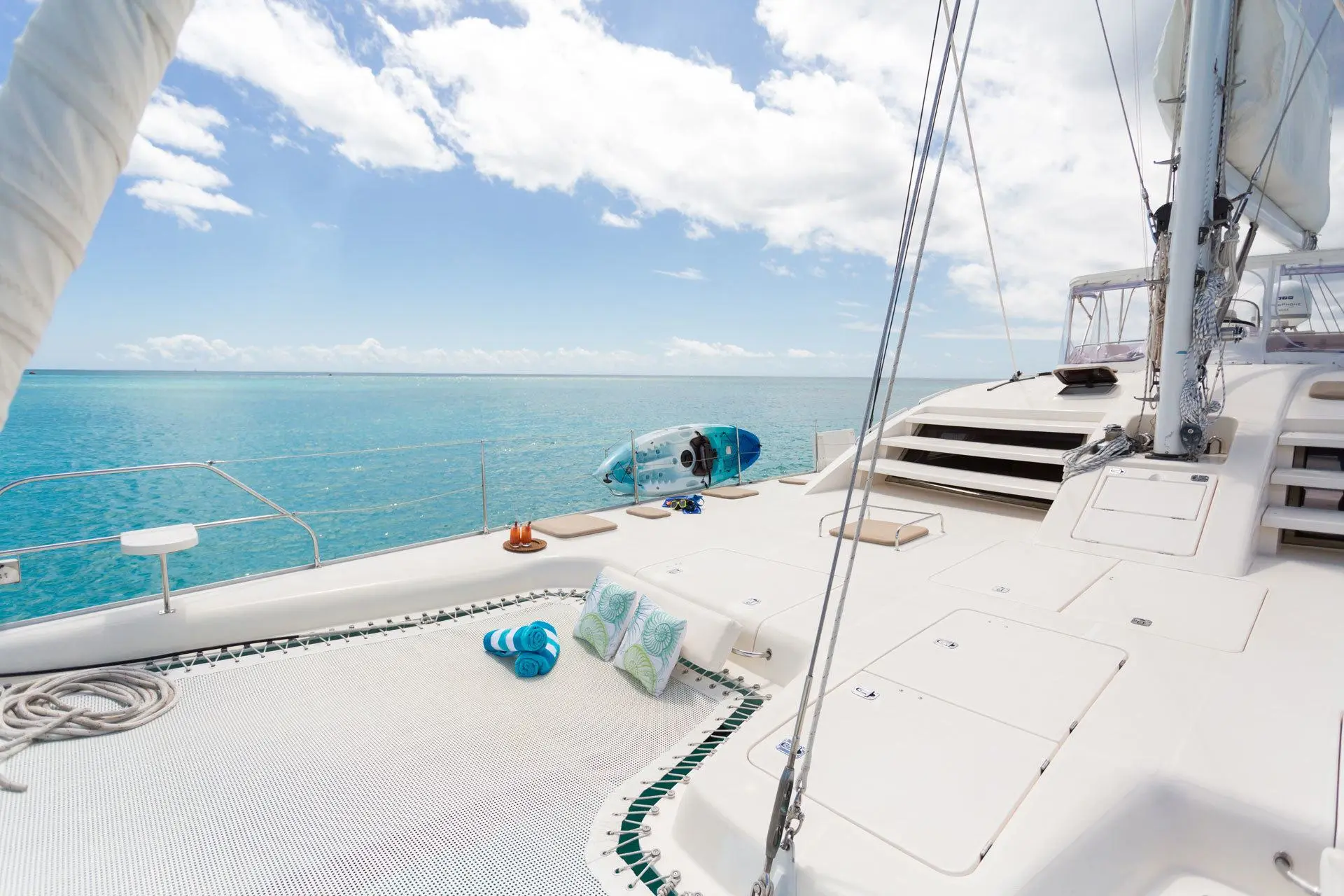 Sun deck with cushioned loungers and kayak