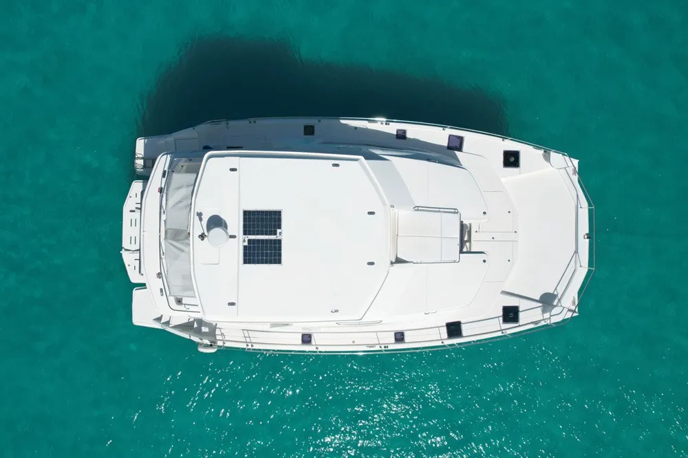 Overhead image of Silver Dancer cruising with guests on deck and turquoise water below